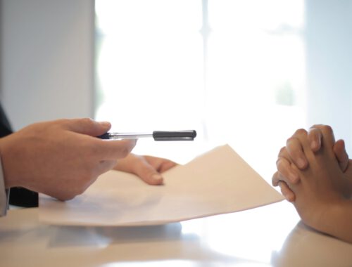 crop businessman giving contract to woman to sign